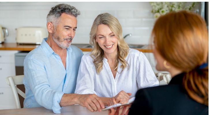happy-mature-couple-meeting-investments-and-financial-advisor-at-home-SmartAsset
