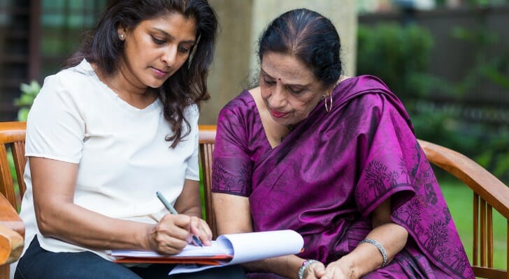 An Indian woman working on her living will with a lawyer.