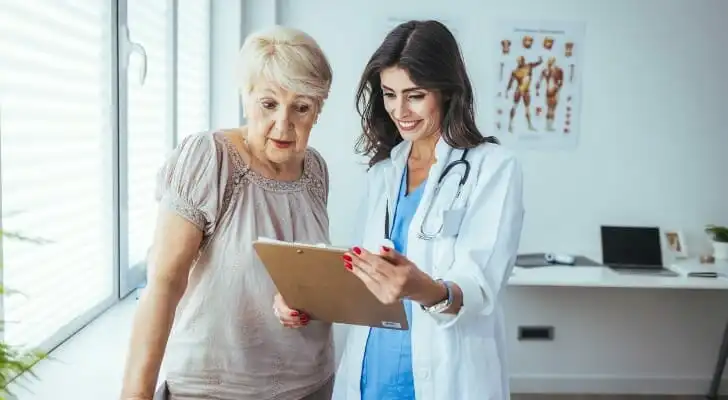 the-doctor-is-explaining-something-on-the-clipboard-SmartAsset