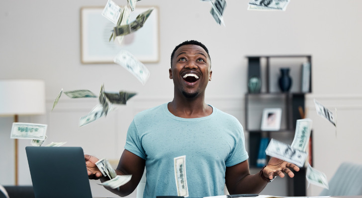 A man throwing money up into the air.