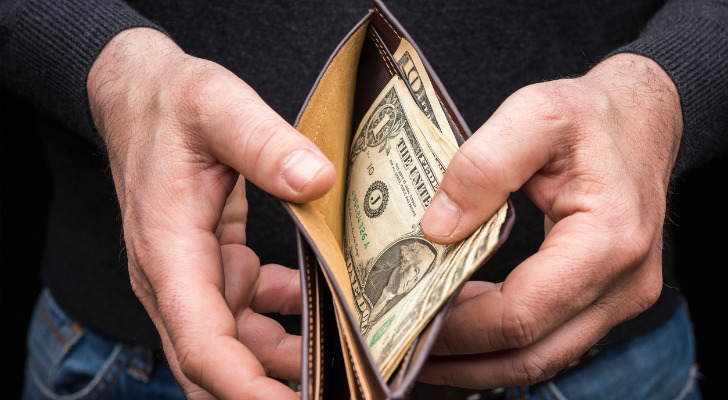 A man opening his wallet.