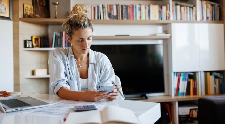 A woman preparing to place a stop payment on a check.