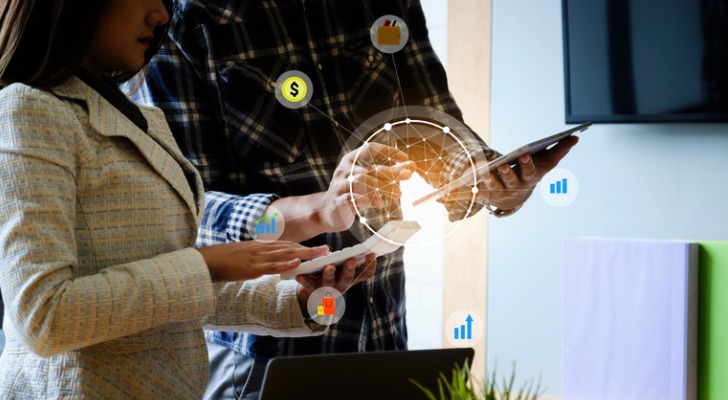 business-team-discuss-at-meeting-room-with-virtual-icon-money-or-insurance-concept-SmartAsset