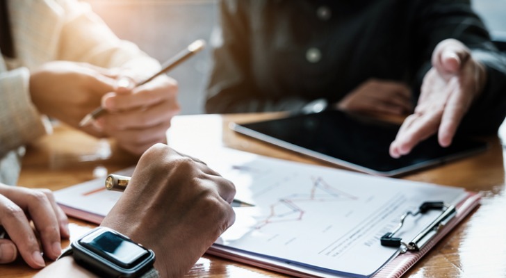 fund-managers-team-discuss-researching-and-analysis-investment-stock-market-SmartAsset