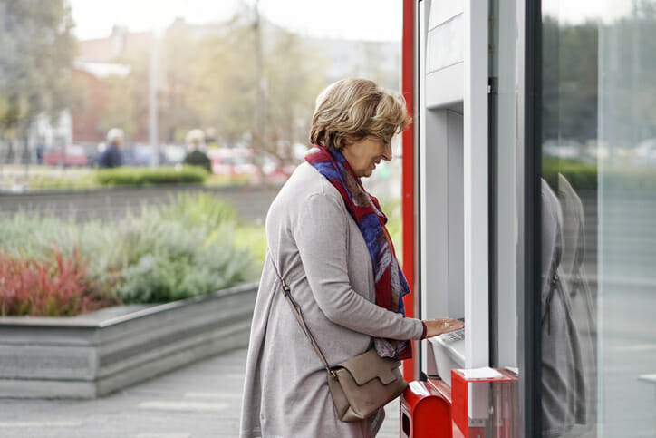 A woman withdrawing money from an ATM.