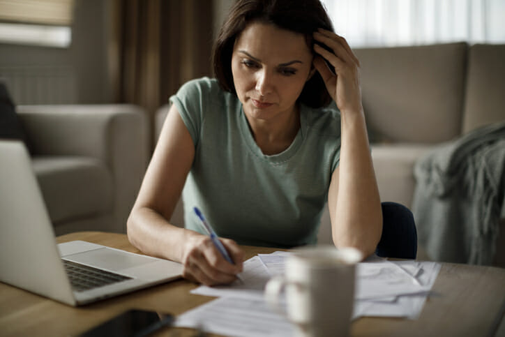 A woman reviewing her bills during a recession.