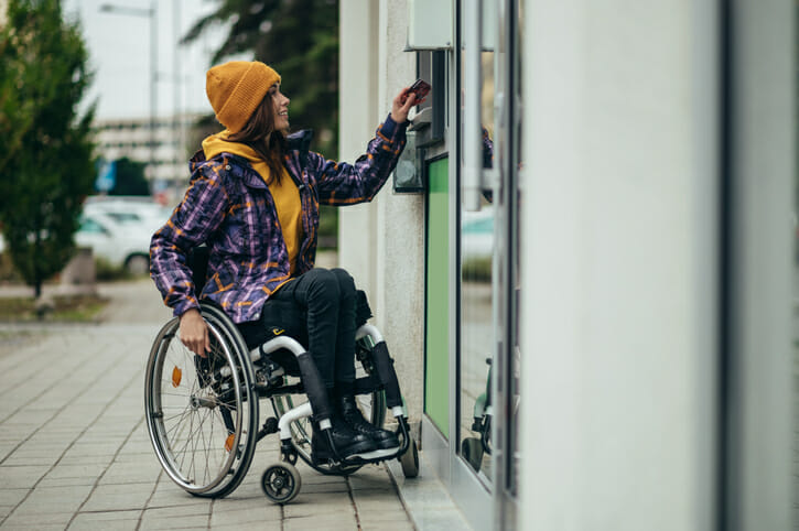 A woman using her ATM card to make a withdrawal.