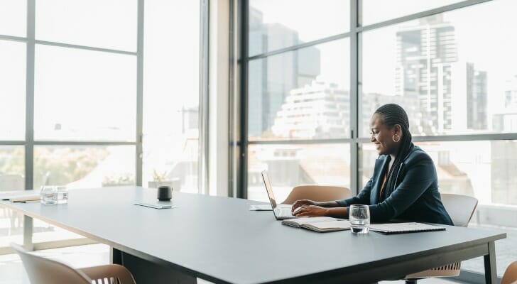 A business woman looking up the income threshold for 1% earners.