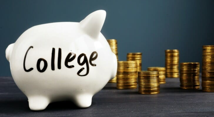 A white piggy bank with the word "College" written in black marker.