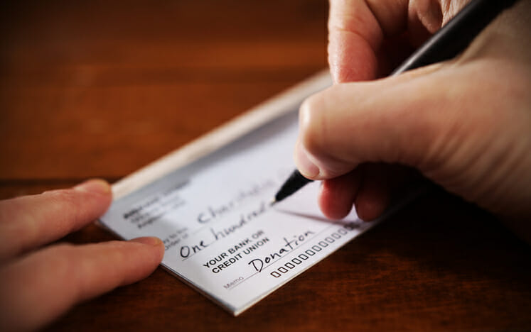 A taxpayer writes a check for a church donation.