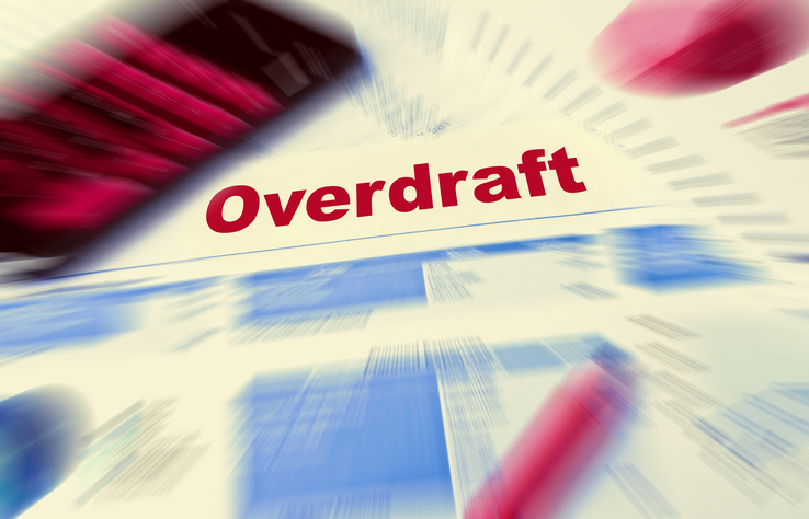 Closeup of a bank statement with the word "Overdraft" in red print.