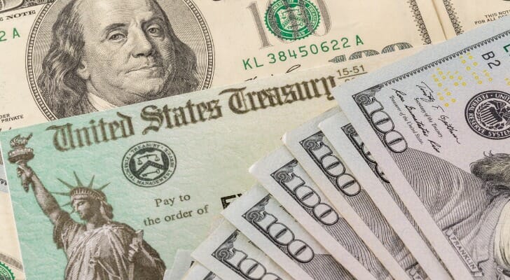 An image of a U.S. Treasury check and cash.