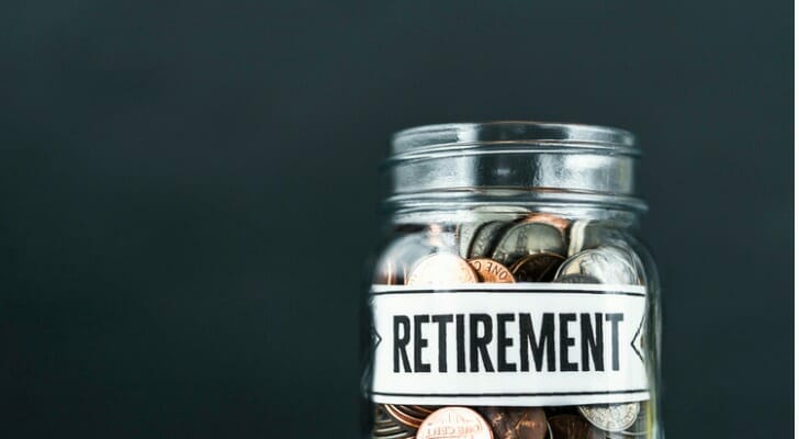 money-background-of-glass-jar-filled-with-coins-and-retirement-message-SmartAsset