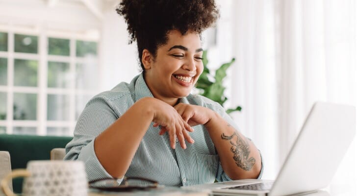 A woman reviewing loan modification vs. refinance.