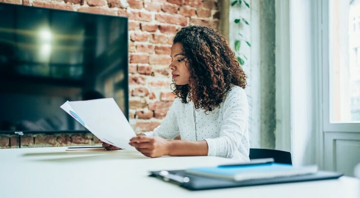 A woman researches the best ways to invest $25,000.