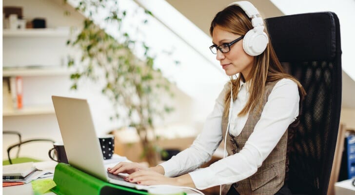 A woman listens to one of the best podcasts for financial advisors.