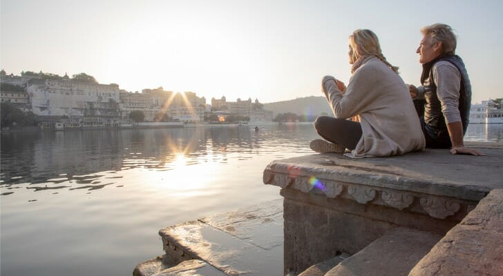 A couple watching the sunset, having retired at 55 with $5 million.