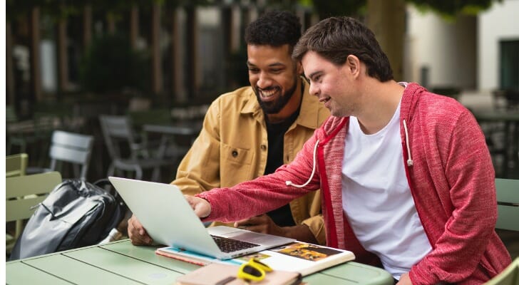 Two young men research whether or not a grown child can collect parents' Social Security.