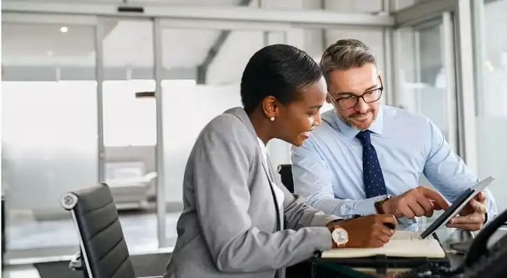 Two financial advisors reviewing their client base.