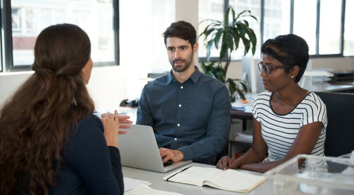 A couple sit down with a small business tax advisor.