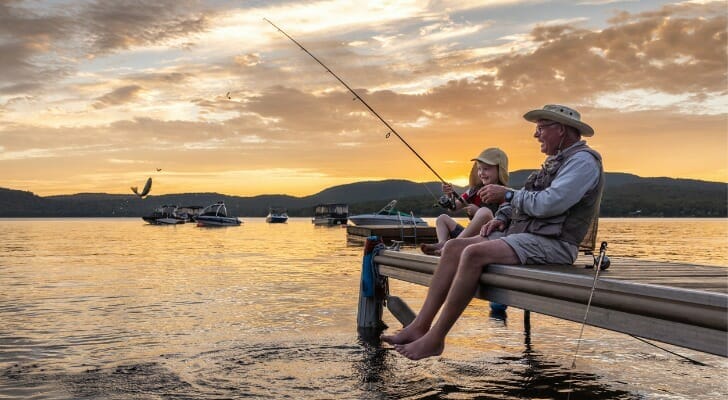 A man fishing with his granddaughter, having retired at 70 with $2 million.