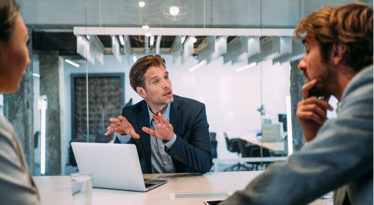 Financial advisors reviewing a client acquisition strategy.