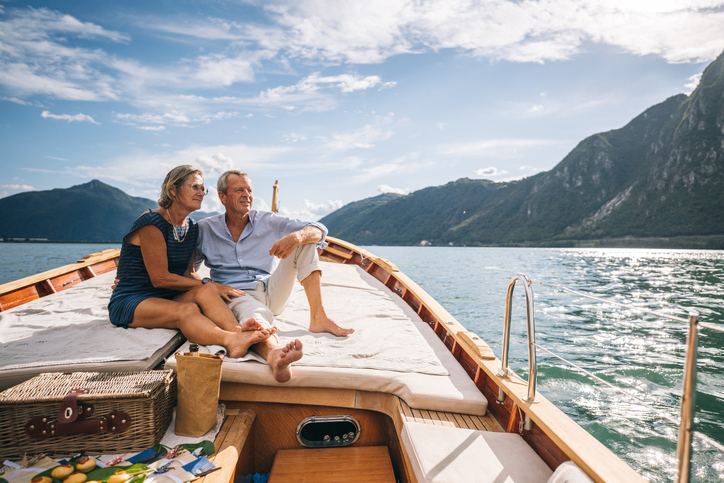 A couple on a boat, having retired at 55 with $6 million.