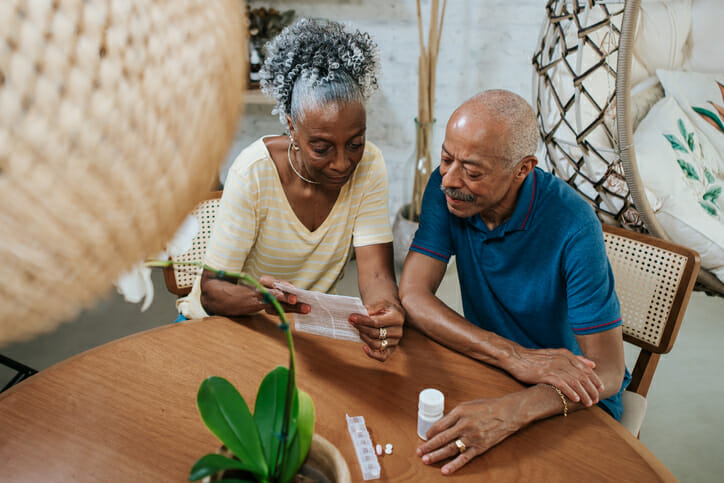 A senior couple reviewing Medicare prescriptions.