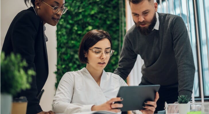 Small business tax advisors review and discuss an account.