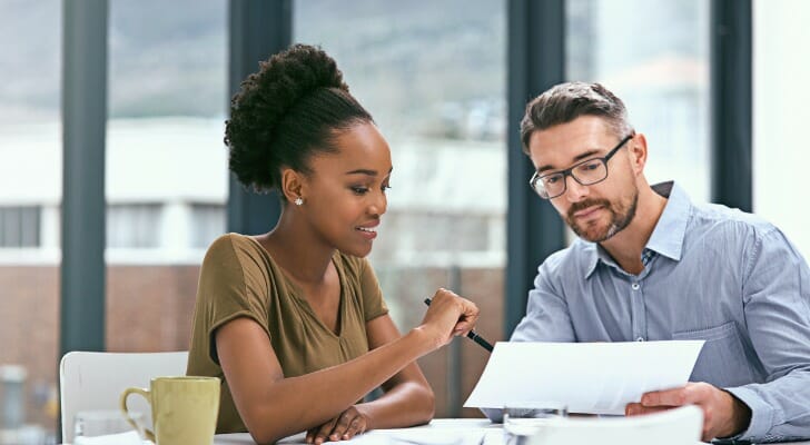 A small business tax advisor sits down with their client.