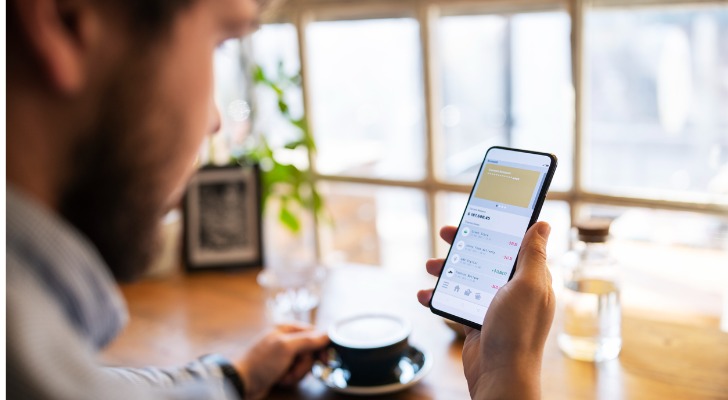 A man checking his bank account on his mobile app.