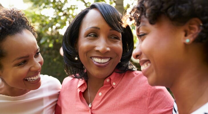 Three siblings reuniting at a family event.