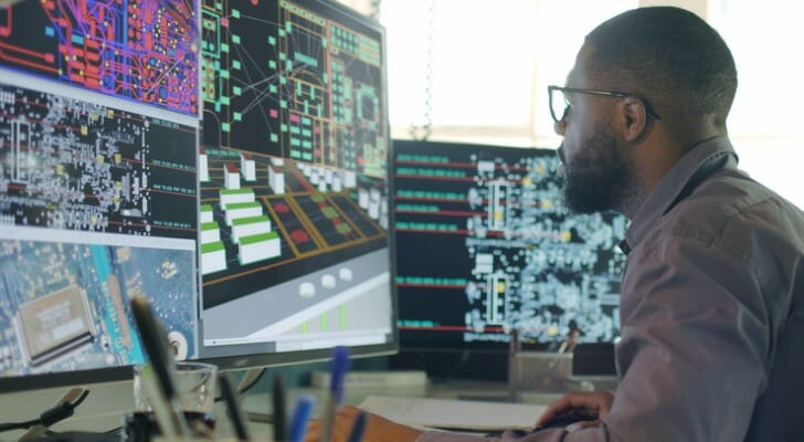 An investor at a computer, contemplating how to invest in AI.