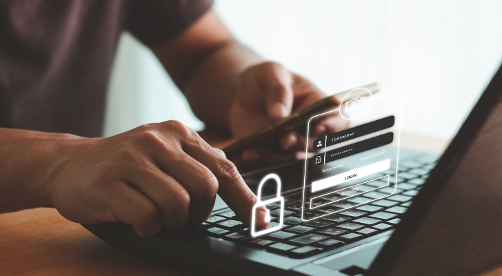 A man signing into his bank account online.