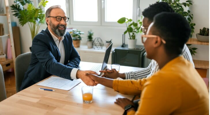 A couple meeting a tax expert to help them file their taxes.