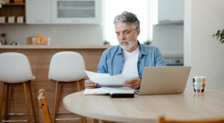 A man reviewing how much interest his checking account earns.