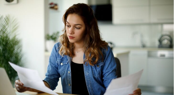 A woman reviews tax documents.