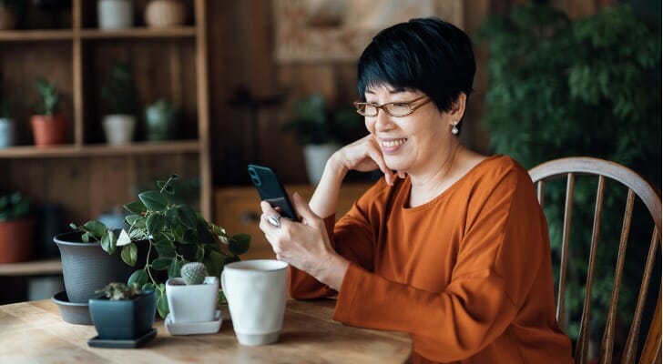 A woman on her smartphone, reviewing Regulation E.