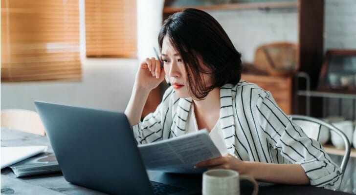 A woman reviewing tax form options for TurboTax and FreeTaxUSA.