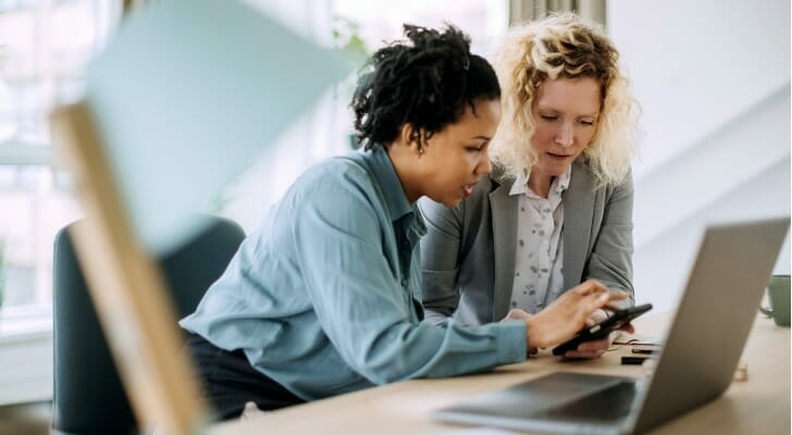 Two advisors looking at a day in the life of a financial advisor.