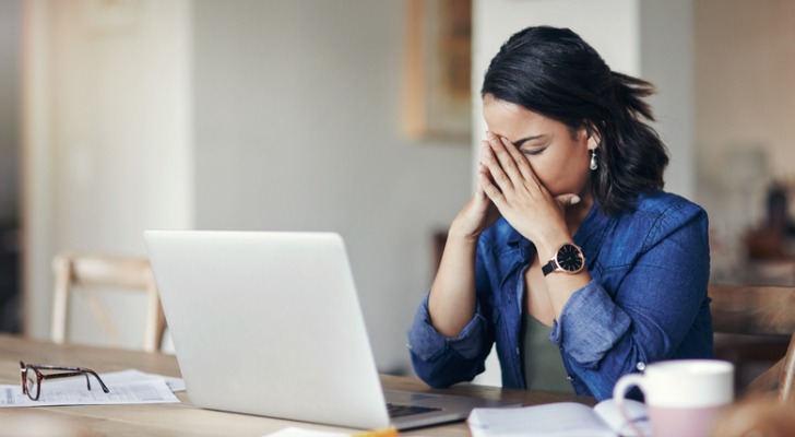 A woman looking at her online bank account, wondering, "Is my money safe in the bank?"