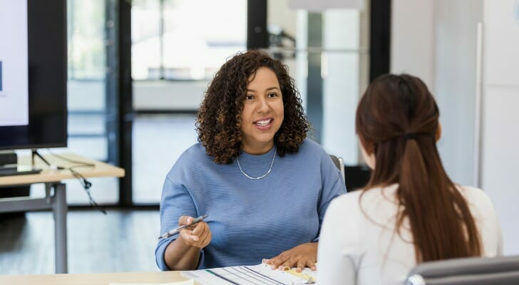 A financial advisor who recently opened her own financial advisory business meets with a client.