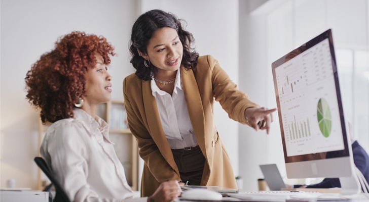 Two advisors reviewing a prospecting strategy to acquire new clients.