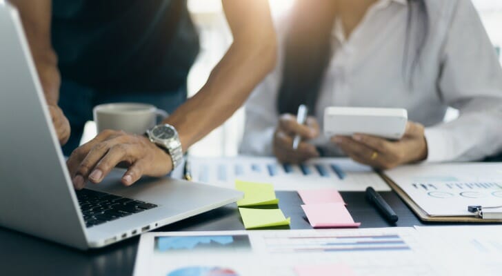 Two women review what happens to your tax liability with proper financial planning.