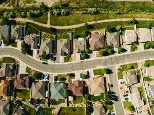 An aerial view of a suburban street with houses.