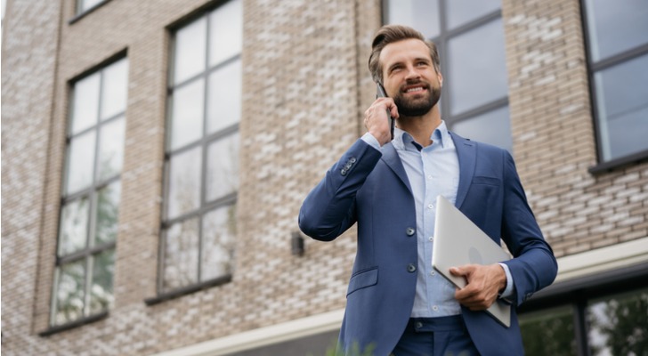 A real estate investor calls his partner after touring a property that's for sale.