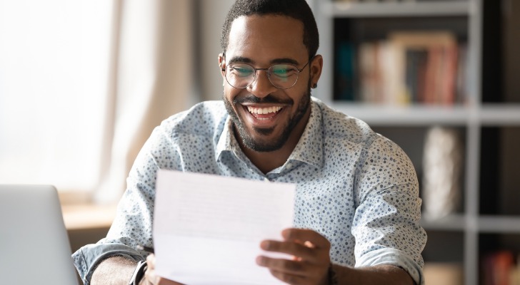 A young man reads a document about his tax-advantaged plan.