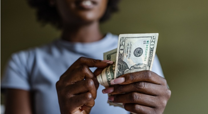 Woman counts up her cash income