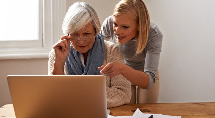 Woman and daughter check the woman's dividend payment