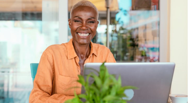 A retiree who does freelance blogging works at her computer.